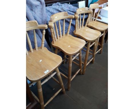 A SET OF FOUR LIGHT WOOD BAR STOOLS