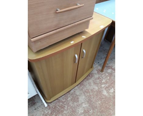 A LIGHT WOOD EFFECT CUPBOARD