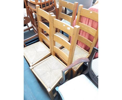 A SET OF FOUR LIGHT WOOD RUSH SEATED LADDER BACK CHAIRS
