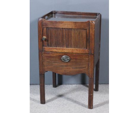 A George III mahogany rectangular tray top bedside cabinet, the sides with two handle cut-outs, enclosed by tambour shutter, 