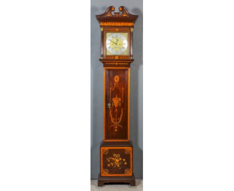 An Edwardian inlaid mahogany longcase clock by Maple &amp; Co. of London, the 11ins square brass dial with wide silvered chap