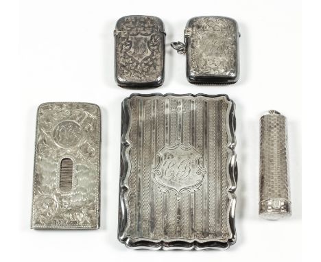 A Victorian silver rectangular note/card case of shaped outline engraved with monogram within shield shaped cartouche and eng