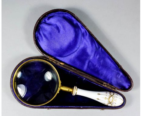 A late 19th Century engine turned gilt brass mounted magnifying glass with gilt and white porcelain handle, 8.5ins, with orig