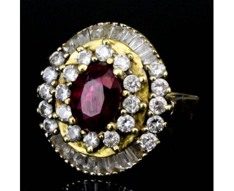 A modern gold coloured metal mounted ruby and diamond cluster ring, set with central ruby (approximately 1ct), surrounded by 