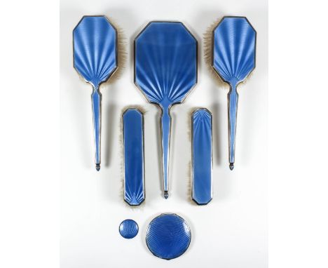 A George V silver and blue enamel backed five piece dressing table set with engine turned backs, comprising - hand mirror, tw