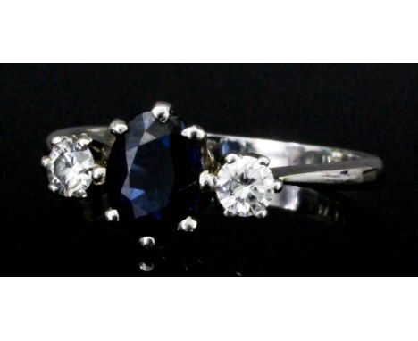 A platinum mounted sapphire and diamond three stone ring (approximate total diamond weight .70ct) (size K - gross weight 3.2 