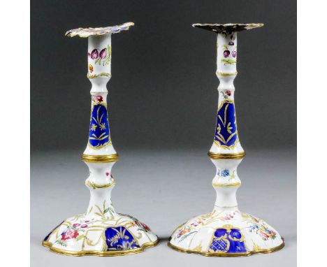 A matched pair of English 18th Century enamel tapersticks, each enamelled and gilt with scattered flower sprays, 6.5ins high 