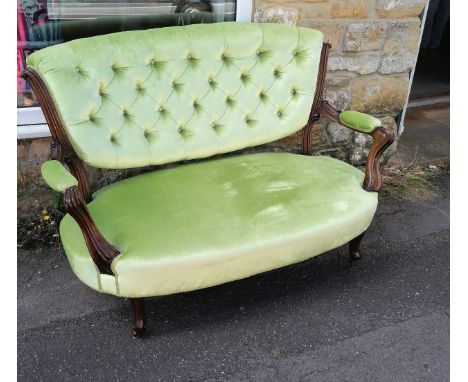 Victorian Walnut framed 2 seater button back settee, upholstered in a green plush fabric, on carved scroll legs, 132 wide, 90