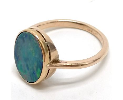 Unmarked 14ct gold black opal ring size N. 2.6g total weight. Surface abrasions to stone, natural faults to back. 