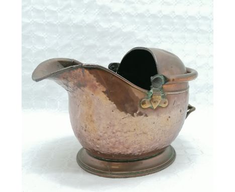Antique copper helmet shaped coal scuttle, heavy used condition with split to lip, 30 cm high, 45 cm length, 27 cm deep. 