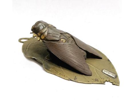 Good quality Oriental bronze bill clip in the form of a cicada on a part eaten leaf with signature to front - 9.5cm long