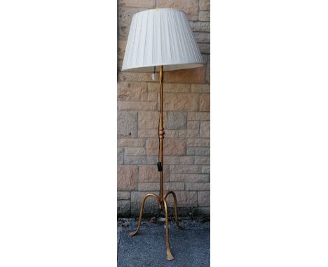 Good quality wrought iron standing lamp with gold leaf style decoration with a cream pleated shade. Measures 167cm tall. 