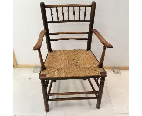 Antique elm rush seated elbow chair, with spindle back rail, on turned legs, 53 cm wide, 83 cm high, 41 cm deep, 42 cm to top