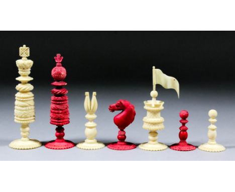 A 19th Century turned and carved ivory and red stained ivory chess set, kings 4.75ins high, pawns 1.75ins high, contained in 