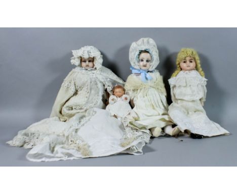 A Victorian wax headed doll with blue glass eyes, cloth body, wax arms and legs, wearing white cotton robe, cream lace trimme