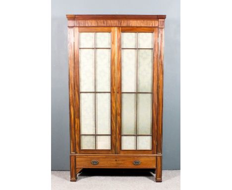 A George III mahogany bookcase with moulded cornice, fitted three adjustable shelves enclosed by a pair of astragal glazed do
