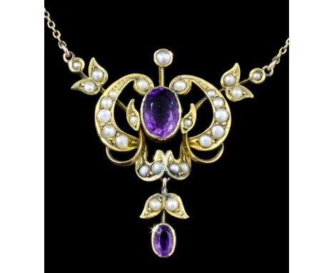 An Edwardian 15ct gold mounted amethyst and seed pearl set pendant necklace, the oval collet set amethyst of approximately 1.