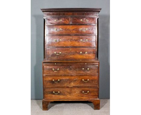 A George III mahogany tallboy, the upper part with moulded cornice, fitted two short and three long drawers with canted corne