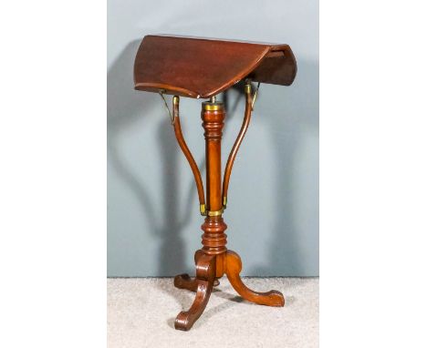 A Victorian walnut oval adjustable reading tripod table with hinged adjustable top, on screw turned central column with shape