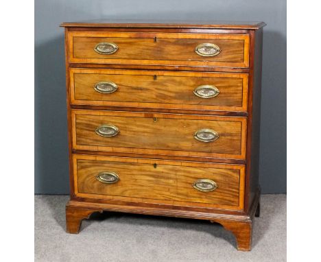 A George III mahogany chest inlaid with ebonised stringings and crossbanded, with moulded edge to top, fitted two short and t