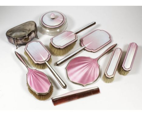 An Edward VIII silver, pink and lilac guilloche enamel backed seven piece dressing table set of "Art Deco" design, comprising