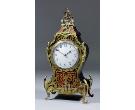 An early 20th Century French red tortoiseshell Boulle and brass mounted mantel timepiece of "Louis XV" design, the 3.25ins wh