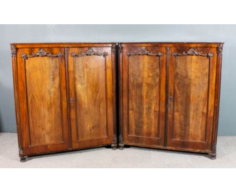 A pair of 19th Century Austrian figured mahogany armoires with moulded edge to top, each fitted two shelves enclosed by a pai
