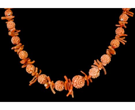 A late 19th Century coral single strand necklace of graduated carved flowerhead beads, forty-nine beads ranging from 5mm to 1