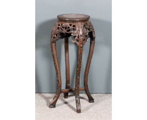 A Chinese stained wood circular jardiniere stand with pink veined marble flush panel to top and beaded edge, the shaped apron