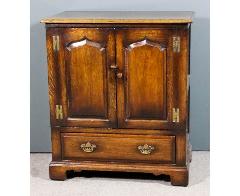 A modern panelled oak television cabinet by Titchmarsh & Goodwin, enclosed by a pair of fielded panelled doors, fitted fall f
