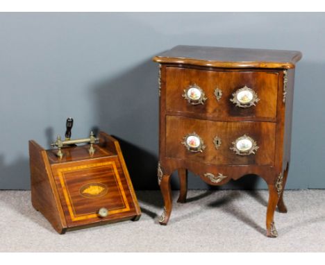 A French walnut and gilt brass mounted serpentine fronted petite commode of "Louis XV" design, with moulded edge to top, fitt