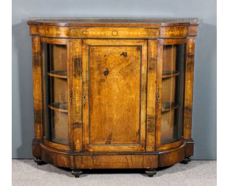 A Victorian figured walnut and gilt metal mounted breakfront credenza inlaid with stringings and arabesques, with gilt metal 