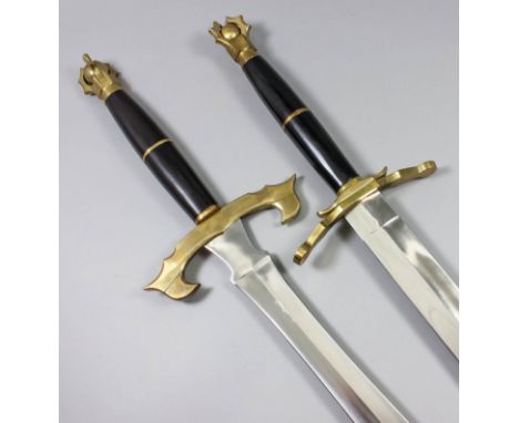 A pair of modern fantasy broadswords, each with 30ins bright steel double edged blade, heavy brass cross guard and pommel, an