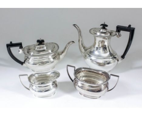 An Elizabeth II silver rectangular four piece tea and coffee service with gadroon mounts, ebonised finials and angular loop h