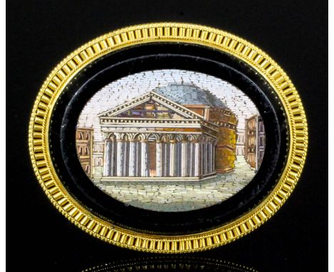 A late 19th Century gold coloured metal mounted oval pattern micromosaic panel of a Roman temple, 50mm x 40mm overall Note: M