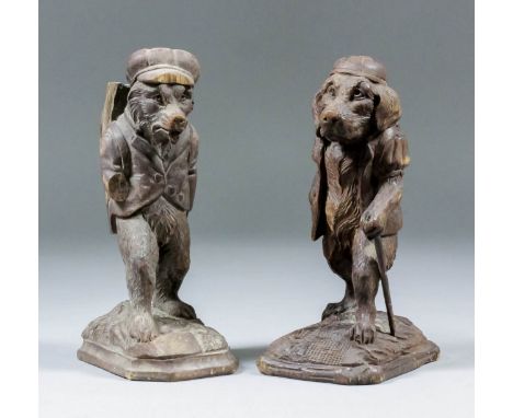 A pair of Black Forest carved anthropomorphic figures of a bear and dog in hunting dress, 6.75ins high