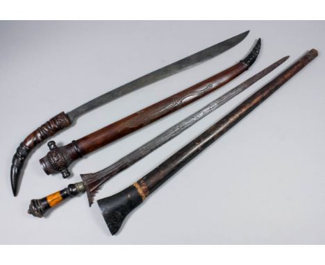 A Far Eastern native short sword, with 17.5ins single edged blade, carved hardwood grip and scabbard, 28ins overall and one o