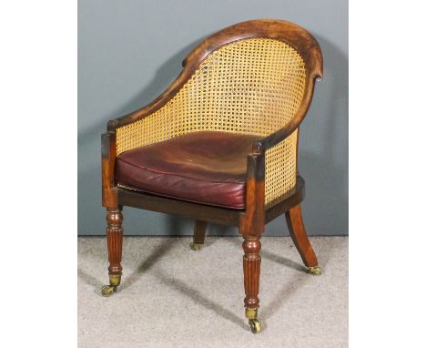 A William IV rosewood framed tub-shaped Bergere armchair, the arched back with scroll carvings, re-caned seat and panel to ba