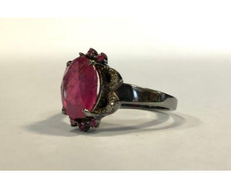 A dark vintage finish ruby and diamond ring, 3.2ct, natural oval stone, silver mount 