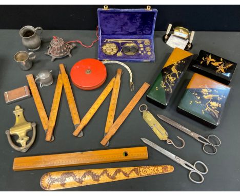 A brass door knocker;  a cast iron turtle string dispenser;  three lacquered boxes;  treen ruler;  level;  tape measure;  sca