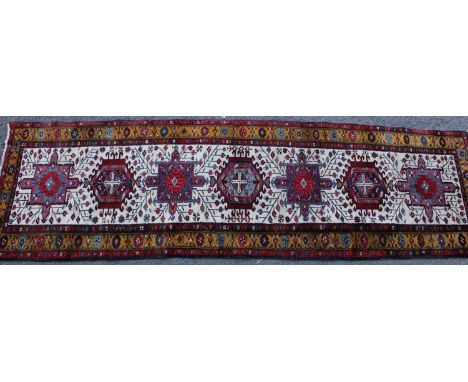 A Persian hand-made Heriz runner, 332cm x 96cm 