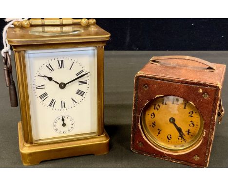A brass carriage clock, Roman numerals, subsidiary seconds dial, 10cm high;  a  travel clock, in case (2) 