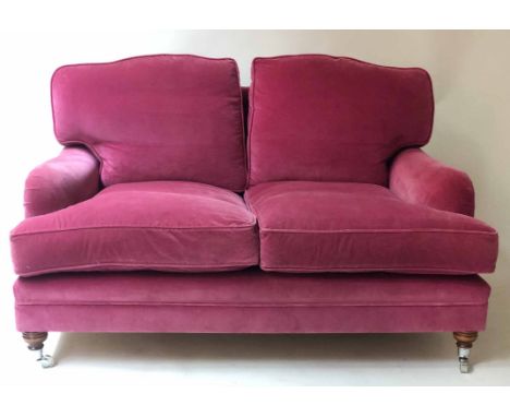 HOWARD STYLE SOFA, deep pink velvet upholstered with feather filled pads and turned front supports, (possibly George Smith) 1