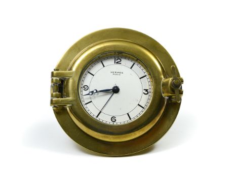 HERMES ParisSabord table clockGilt brass shaped like a porthole, Breguet hands in blued steel, dial with Arabic numerals, sig