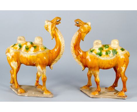 Chinese pair of ceramic dromedaries, hand formed and naturalistic painted and glazed on canted bases, in manner of the Han Dy
