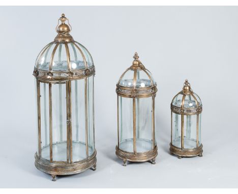 Set of lanterns, three items in different size, round form with arched top and hexagonal sections on claw feet with one door,