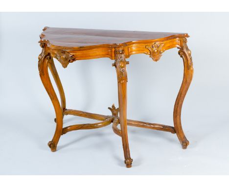 Piemontese console table on four curved legs with border connection, curved upper border and top with rich carved decorations