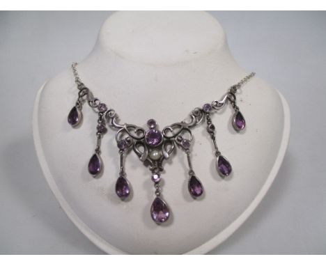 An early 20th century style silver, amethyst and pearl necklace, the central bouton pearl set below a round faceted amethyst 