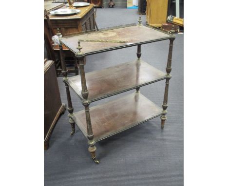 A French Amboyna wood etagere, late 19th century of three shelves with a three quarter gilt brass gallery and fruit cast fini