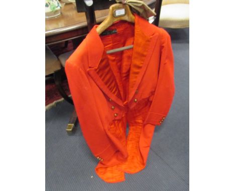 Lord Luke's hunting pink coat, with Oakley Hunt buttons, and a candlestick made for the Oakley Hunt, from Odell Castle, showi